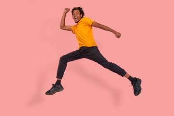 Fototapeta na wymiar Full length body profile side photo of positive cheerful funky black guy hear about wonderful black Friday sales jump run want be first wear casual style outfit isolated over a pink color background