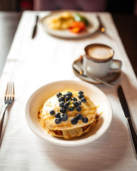 Beautiful breakfast - pancakes with blueberries and coffee, top view