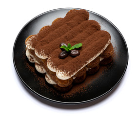 Classic tiramisu dessert on ceramic plate isolated on white background with clipping path