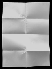 white uneven sheet of paper on the black background