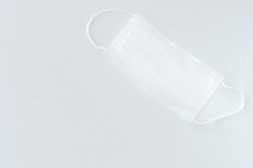 Medical mask with rubber ear straps. Typical disposable mask to cover the mouth and nose.