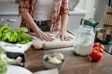 Obraz na płótnie Canvas Woman in kitchen. Beautiful lady baking bread.