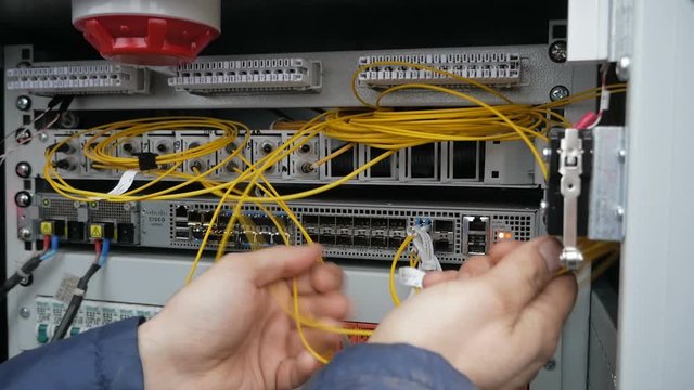 man working in network server room