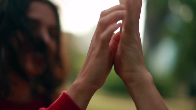 Joining hands together at the park, friendship symbol