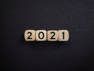 New year concept. 2021 written on wooden blocks. Vintage styled background.