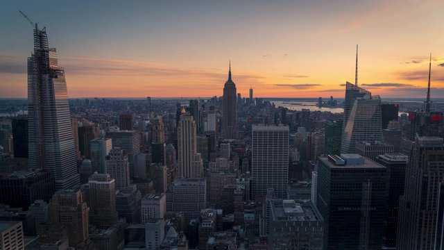 Time lapse of southern Manhattan during sunset from the top of the rock observatory. Beautiful city views, lights and clouds moving. New York City , Manhattan NYC, USA.