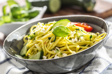 Spaghetti zucchini raw vegan pasta with feta cheese cucumber and basil