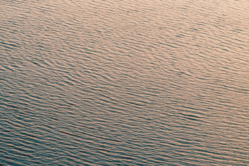 Water surface of the river in the rays of the evening setting sun	