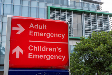 Adult emergency and children's emergency red sign out side of a hospital