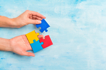 hands playing a puzzle symbol of Public awareness for autism spectrum disorder