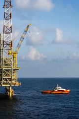 A fast crew boat approaching by snatching method to an oil prodcution platform at oil field