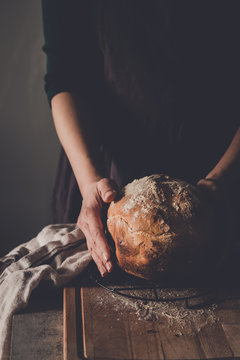 Woman's hands holding homemade bread