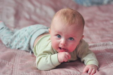 baby lying on bed