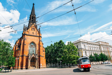 Old town street, The Church of Jan Amos Comenius Red Church and tram in Brno, Czech Republic - obrazy, fototapety, plakaty