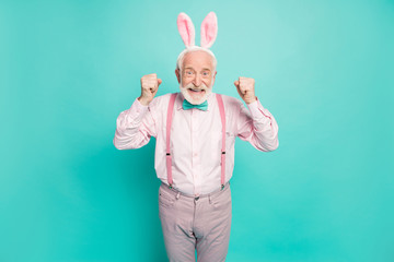 Portrait of cool funky old man with bunny headband celebrate easter party event win traditional...