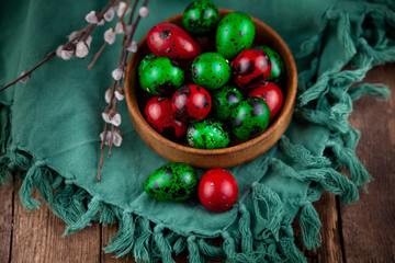 Easter eggs background. Green and red eggs. Colorful Quail colored eggs. Place for text. Different little painted egg set. Dietary nutrition. 