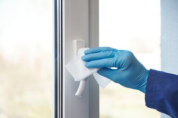 sanitizer disinfection of handles on windows and doors in rooms.