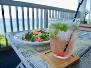 海の景色と冷たいドリンクとサラダ