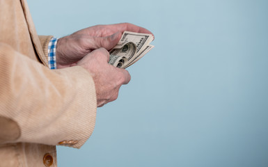 money in a hand over blue background