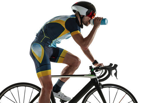 Triathlon Male Athlete Cycle Training Isolated On White Studio Background. Caucasian Fit Triathlete Practicing In Cycling Wearing Sports Equipment. Concept Of Healthy Lifestyle, Sport, Action, Motion.