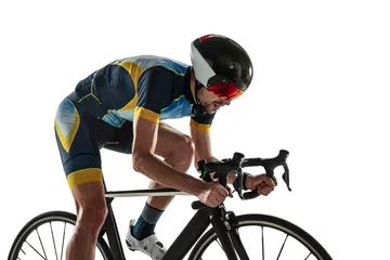 Poster Triathlon male athlete cycle training isolated on white studio background. Caucasian fit triathlete practicing in cycling wearing sports equipment. Concept of healthy lifestyle, sport, action, motion. © master1305