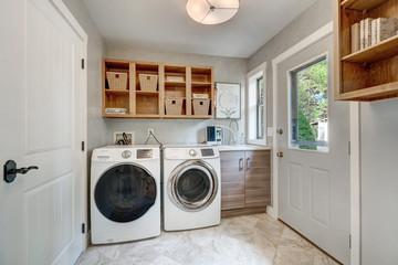 Laundry room with beautiful chelving and natural tones. 