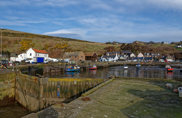 The closed wooden Inner storm Gates at Gourdon Harbour protecting the moored Fishing Boats and Yachts from water surge.