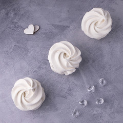 Obraz na płótnie Canvas delicate white marshmallows with hearts and shiny stones