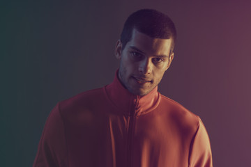 Studio close-up portrait of attractive male model. Color flash studio light