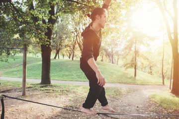 Young caucasian man slacklining outdoor