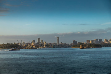 Fototapeta premium The skyline of Sydney, New South Wales in Australia during a cloudy but warm day in summer.