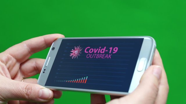 Graphic animation of Coronavirus outbreak displayed on smartphone holding by woman hands, green screen