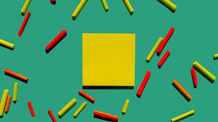 yellow post it papers and green background with some roll papers