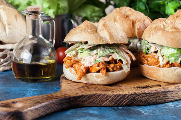 Pulled chicken sandwich with salad and bbq sauce