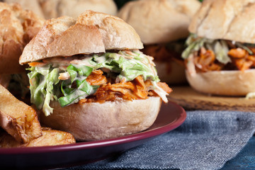 Pulled chicken sandwich with salad and bbq sauce