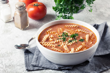 Tomato soup with fusilli pasta in the bowl