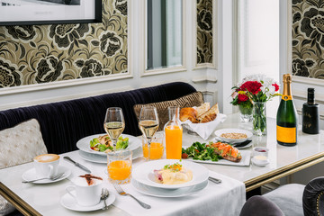 Brunch with poached eggs, fruit, orange juice and cava