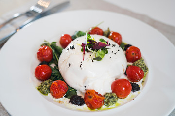 Mozarella with cherry tomato and green pesto