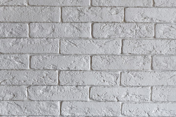 Interior brickwork of white decorative plaster brick on the wall. Loft style interior design.