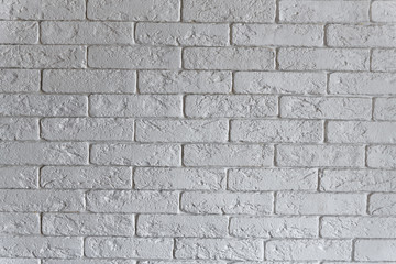 Interior brickwork of white decorative plaster brick on the wall. Loft style interior design.