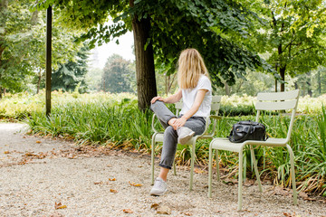A beautiful caucasian woman walks in a public park. Outdoor activities, relaxed lifestyle. Happy...
