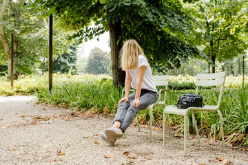A beautiful caucasian woman walks in a public park. Outdoor activities, relaxed lifestyle. Happy...