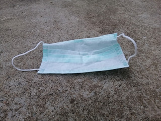 Used medical face mask on the floor, masks can protect anti-bacteria anti-virus and Coronavirus Disease COVID-19.