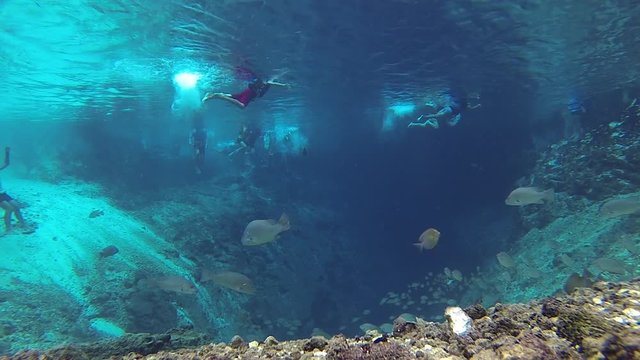 People enjoying the clear waters of Enchanted River. Enchanted river in Hinatuan, Surigao del Sur is known for its underwater cave and clear waters. It flows into the Philippine sea and Pacific Ocean.