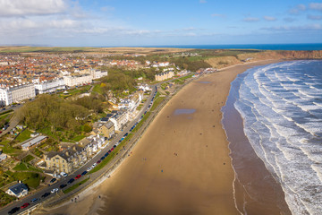 Aerial photo of the British seaside town of Filey, the seaside coastal town is located in East Yorkshire in the North Sea coast showing the beach and ocean.