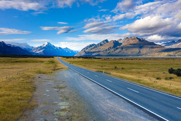 Amazing scenic windy road with mountains and glacier lake, aerial view. MT Cook State Highway 80, New Zealand.