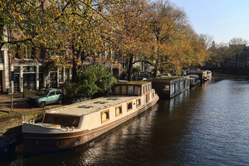 Fototapeta premium Canal with house boats in Amsterdam, Holland