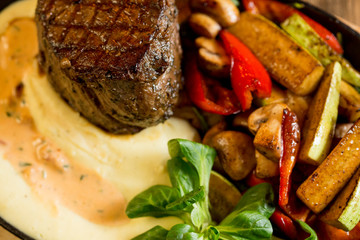 Beef steak with mashed potatoes and grilled vegetables