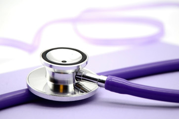 Stethoscope, stethophonendoscope, purple color, concept coronavirus Covid-19 . Measurement of elevated pressure. Treatment of hypertension.