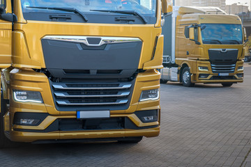 Yellow trucks parked in line at a convention